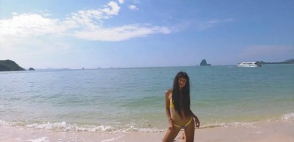  Micro bikini tease by sexy teen who walks on a beach